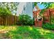View of the backyard with a wooden deck, lawn, and a privacy fence at 12 Byerly Ct, Durham, NC 27713