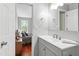 Bathroom with vanity, neutral walls and access to bedroom featuring hardwood floors and natural light at 12 Byerly Ct, Durham, NC 27713