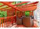 Outdoor deck with a cozy seating area and a wood trellis at 12 Byerly Ct, Durham, NC 27713