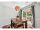 Dining area with a unique pendant light, wood table and access to outdoor space through large windows at 12 Byerly Ct, Durham, NC 27713