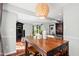 Open concept dining area leads to kitchen and living space, featuring modern lighting and furniture at 12 Byerly Ct, Durham, NC 27713