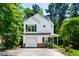Charming two-story home with white siding, green shutters, attached garage, and mature trees at 12 Byerly Ct, Durham, NC 27713