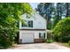 Charming two-story home with white siding, green shutters, attached garage, and mature trees at 12 Byerly Ct, Durham, NC 27713