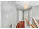 Second floor hallway with hardwood floors and decorative lighting at 12 Byerly Ct, Durham, NC 27713
