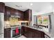 Modern kitchen featuring stainless steel appliances, granite countertops, and dark wood cabinets at 12 Byerly Ct, Durham, NC 27713