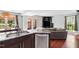 Open-concept kitchen with stainless steel appliances, granite countertops, and access to outdoor space at 12 Byerly Ct, Durham, NC 27713