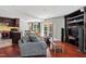 Open-concept living space with hardwood floors, a plush sofa, and seamless flow to the modern kitchen at 12 Byerly Ct, Durham, NC 27713