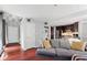 Cozy living space featuring a gray sofa, access to laundry area, and an open flow into the kitchen at 12 Byerly Ct, Durham, NC 27713