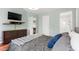 Spacious main bedroom with mounted TV, dresser, and ensuite bathroom access for added convenience at 12 Byerly Ct, Durham, NC 27713