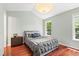 Inviting bedroom with hardwood floors, natural light, and neutral decor, creating a serene retreat at 12 Byerly Ct, Durham, NC 27713