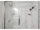 Modern bathroom shower featuring marble-like tile and a sleek glass enclosure at 12 Byerly Ct, Durham, NC 27713
