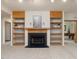 Basement living area featuring a fireplace and built-in bookshelves at 120 Spring Hollow Ln, Cary, NC 27518
