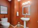 Charming powder room with modern fixtures, unique artwork, and a pedestal sink at 120 Spring Hollow Ln, Cary, NC 27518