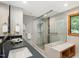 Modern bathroom with a frameless glass shower, designer tile, and vanity with sink at 120 Spring Hollow Ln, Cary, NC 27518
