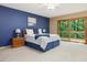 Bright bedroom with plush carpet, an en-suite bathroom, and sliding glass doors to nature at 120 Spring Hollow Ln, Cary, NC 27518
