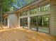 Large deck features multiple sliding glass doors, creating a seamless transition to the serene wooded outdoors at 120 Spring Hollow Ln, Cary, NC 27518