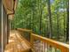 Inviting wooden deck offers scenic views of the lush tree line, creating a tranquil outdoor living space at 120 Spring Hollow Ln, Cary, NC 27518