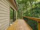 Deck and sliding glass door offers an inviting view of the surrounding trees and greenery, enhancing outdoor living at 120 Spring Hollow Ln, Cary, NC 27518