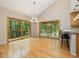 Elegant dining room with hardwood floors, large windows, and easy access to the deck for outdoor dining at 120 Spring Hollow Ln, Cary, NC 27518