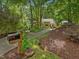 Beautiful exterior view with luscious landscaping and mature trees lining the driveway at 120 Spring Hollow Ln, Cary, NC 27518