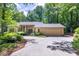 Beautiful single-story home featuring a well-manicured front yard and an attached two-car garage, surrounded by lush trees at 120 Spring Hollow Ln, Cary, NC 27518