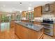 Spacious kitchen featuring granite countertops, custom wood cabinetry, stainless steel appliances and an island at 120 Spring Hollow Ln, Cary, NC 27518