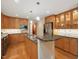 Well-appointed kitchen with custom cabinets, granite countertops, stainless steel appliances, and hardwood floors at 120 Spring Hollow Ln, Cary, NC 27518