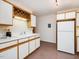 Bright kitchen with white cabinets, wood trim, and ample counter space at 120 Spring Hollow Ln, Cary, NC 27518