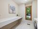 Bright laundry room with a folding counter, patterned tile, and a view of nature at 120 Spring Hollow Ln, Cary, NC 27518