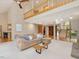 Bright and airy living room with loft, stone fireplace, and seamless flow to the kitchen and outdoor spaces at 120 Spring Hollow Ln, Cary, NC 27518