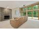 Open living room featuring a stone fireplace, large windows with forest views, and comfortable seating at 120 Spring Hollow Ln, Cary, NC 27518