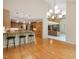 Open-concept living room with hardwood floors, modern lighting, and a cozy stone fireplace at 120 Spring Hollow Ln, Cary, NC 27518