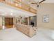 Spacious living room with stone fireplace, high ceilings, natural light, and loft, perfect for relaxing at 120 Spring Hollow Ln, Cary, NC 27518