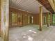 Covered brick patio with sliding glass doors showcases a versatile outdoor living area with sturdy support beams at 120 Spring Hollow Ln, Cary, NC 27518