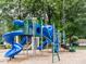 Community playground with colorful climbing structures, slides, and a picnic table, perfect for Gathering fun at 120 Spring Hollow Ln, Cary, NC 27518