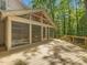 Relaxing porch with screened-in room and wooden deck offers serene views of the surrounding wooded landscape at 120 Spring Hollow Ln, Cary, NC 27518