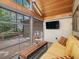 Cozy sunroom with a flat screen television and multiple windows overlooking the back yard at 120 Spring Hollow Ln, Cary, NC 27518