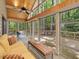 Bright sunroom with wood ceilings, large windows, and comfortable seating at 120 Spring Hollow Ln, Cary, NC 27518