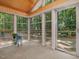 Inviting sunroom provides ample natural light and views of the wooded exterior at 120 Spring Hollow Ln, Cary, NC 27518