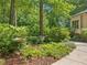 Serene yard featuring lush greenery, mature trees, and garden accents, creating a peaceful outdoor retreat at 120 Spring Hollow Ln, Cary, NC 27518