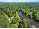 Stunning aerial view of a waterfront community surrounded by dense forests and a winding river at 135 Sagamore Dr, Louisburg, NC 27549