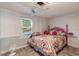 Comfortable bedroom with a colorful bedspread, ceiling fan, and window views at 135 Sagamore Dr, Louisburg, NC 27549