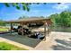 Covered boat dock with multiple boat and golf cart parking spots on a serene lake at 135 Sagamore Dr, Louisburg, NC 27549