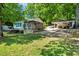 Lush lawn with trees leading to waterfront featuring screened in porch at 135 Sagamore Dr, Louisburg, NC 27549