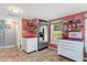 Functional kitchen with stainless steel refrigerator, ample storage, and open shelving at 135 Sagamore Dr, Louisburg, NC 27549