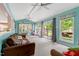 Bright living room featuring oversized windows with lake views, ceiling fans, and a plush couch at 135 Sagamore Dr, Louisburg, NC 27549