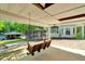 Relaxing outdoor patio featuring a cozy swing, boat dock, and serene waterfront views at 135 Sagamore Dr, Louisburg, NC 27549