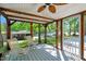 Relaxing screened porch featuring rocking chairs and serene views of the surrounding lake at 135 Sagamore Dr, Louisburg, NC 27549