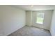 This cozy bedroom features neutral carpet and ample natural light from a window overlooking a green landscape at 147 Gobbler Dr, Smithfield, NC 27577