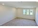 Bright bedroom featuring plush carpeting and a large window, offering a cozy and inviting atmosphere at 147 Gobbler Dr, Smithfield, NC 27577
